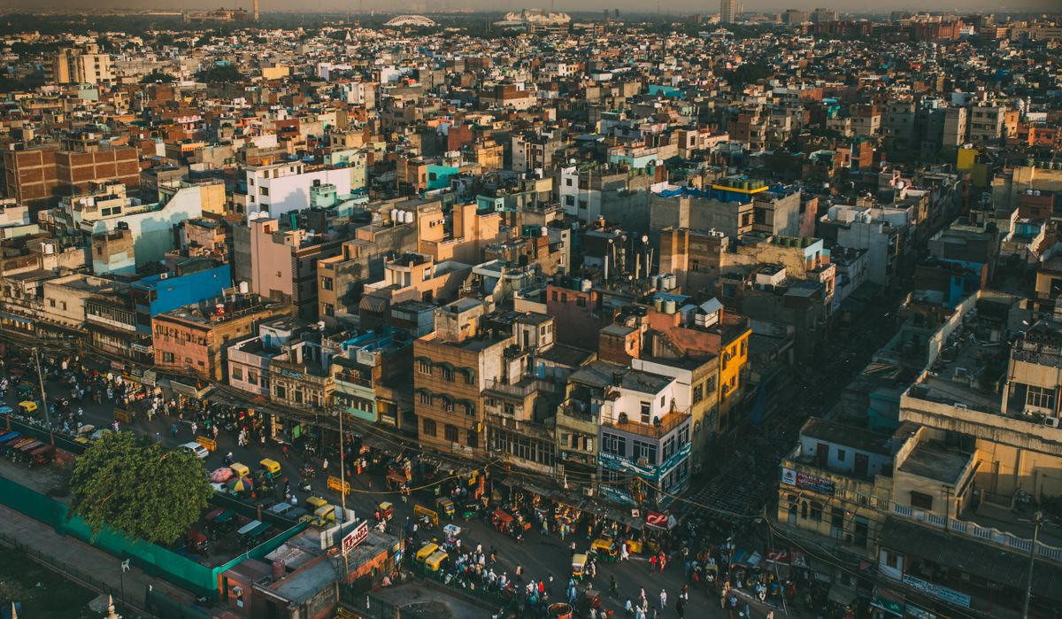 Aerial view of a dense Indian city showing streets and rooftops