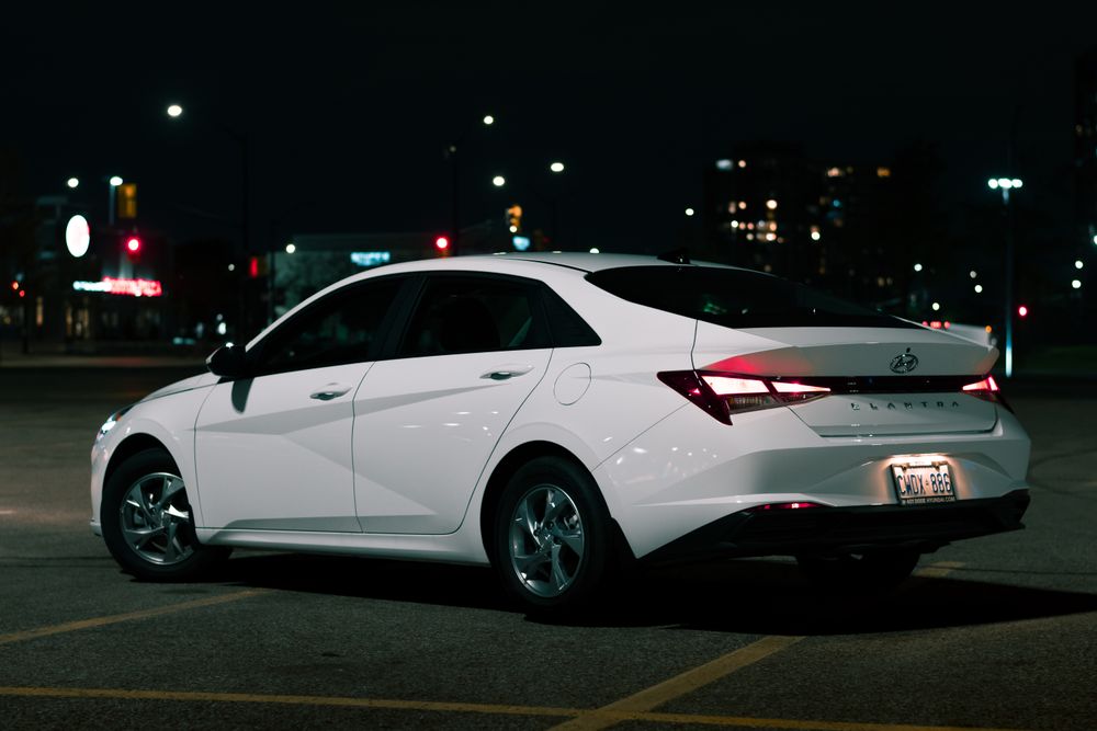 Honda City sedan parked outside a corporate office
