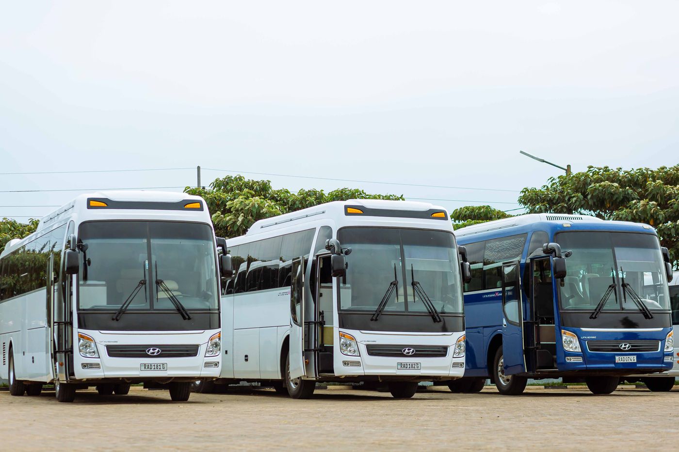 Row of coaches and vans parked outside a convention centre during a corporate conference